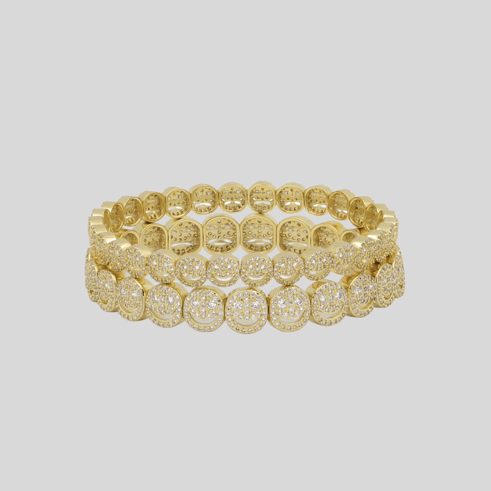 Gold bracelet on a light gray background