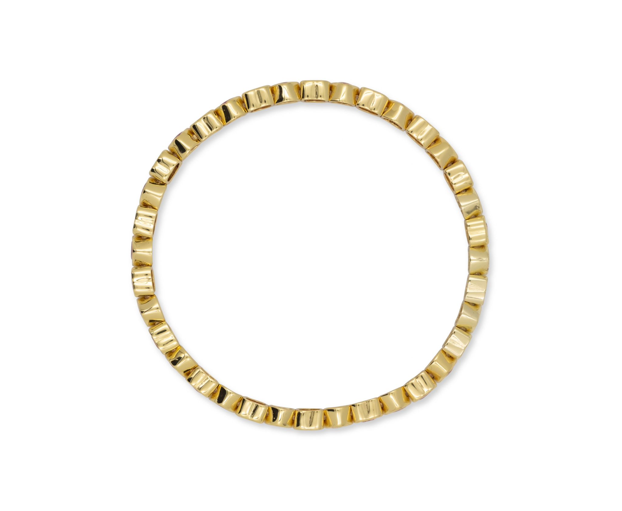 A gold-plated circular ring with a textured, segmented outer edge, shown against a plain white background.