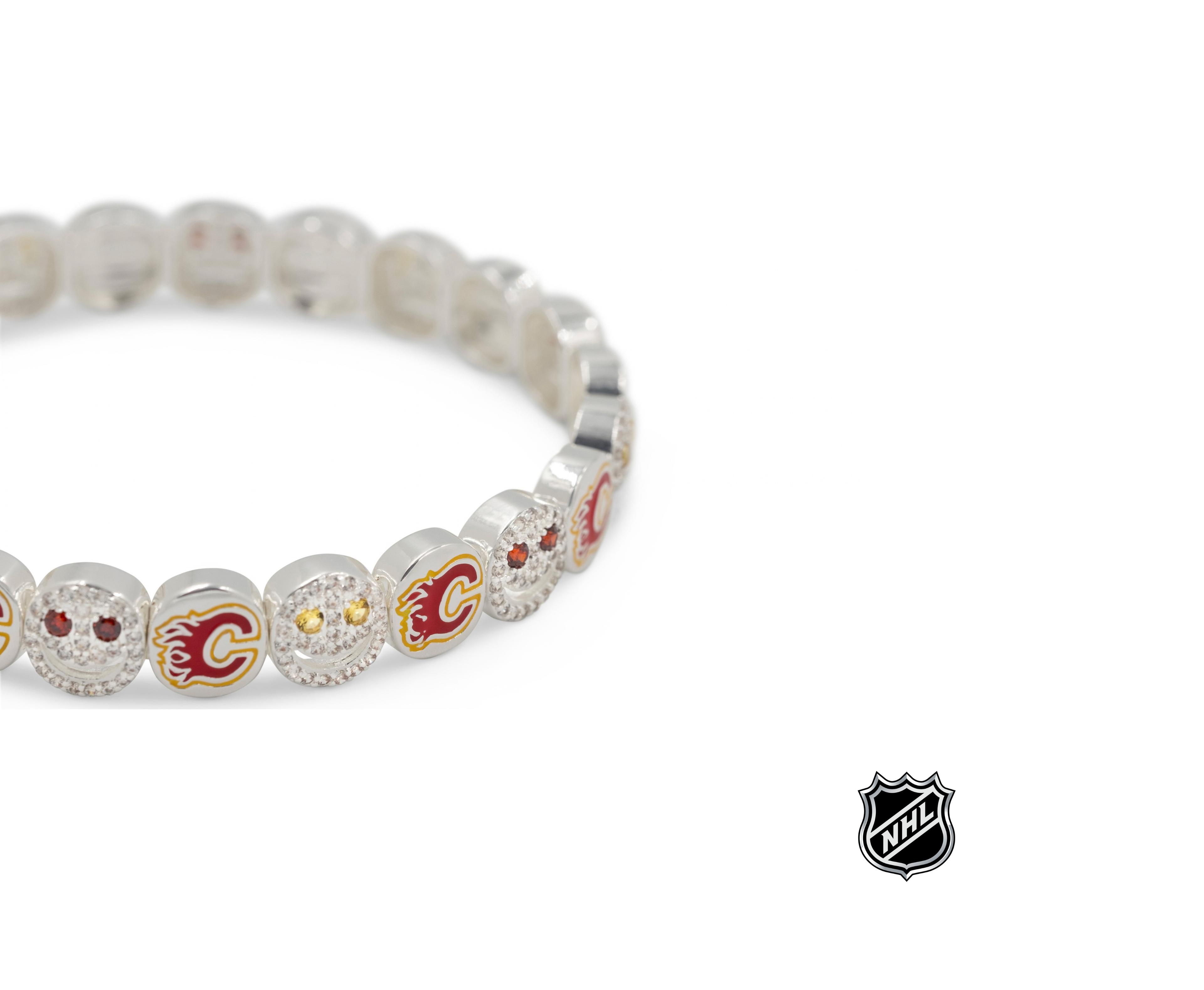 Close-up of white beaded bracelet with red and gold team logos and rhinestone details.