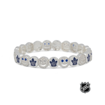 White beaded stretch bracelet with blue maple leaf emblems and crystal-like detail.
