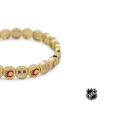 Gold-tone NHL charm bracelet with round colorful team logo charms and sparkling details