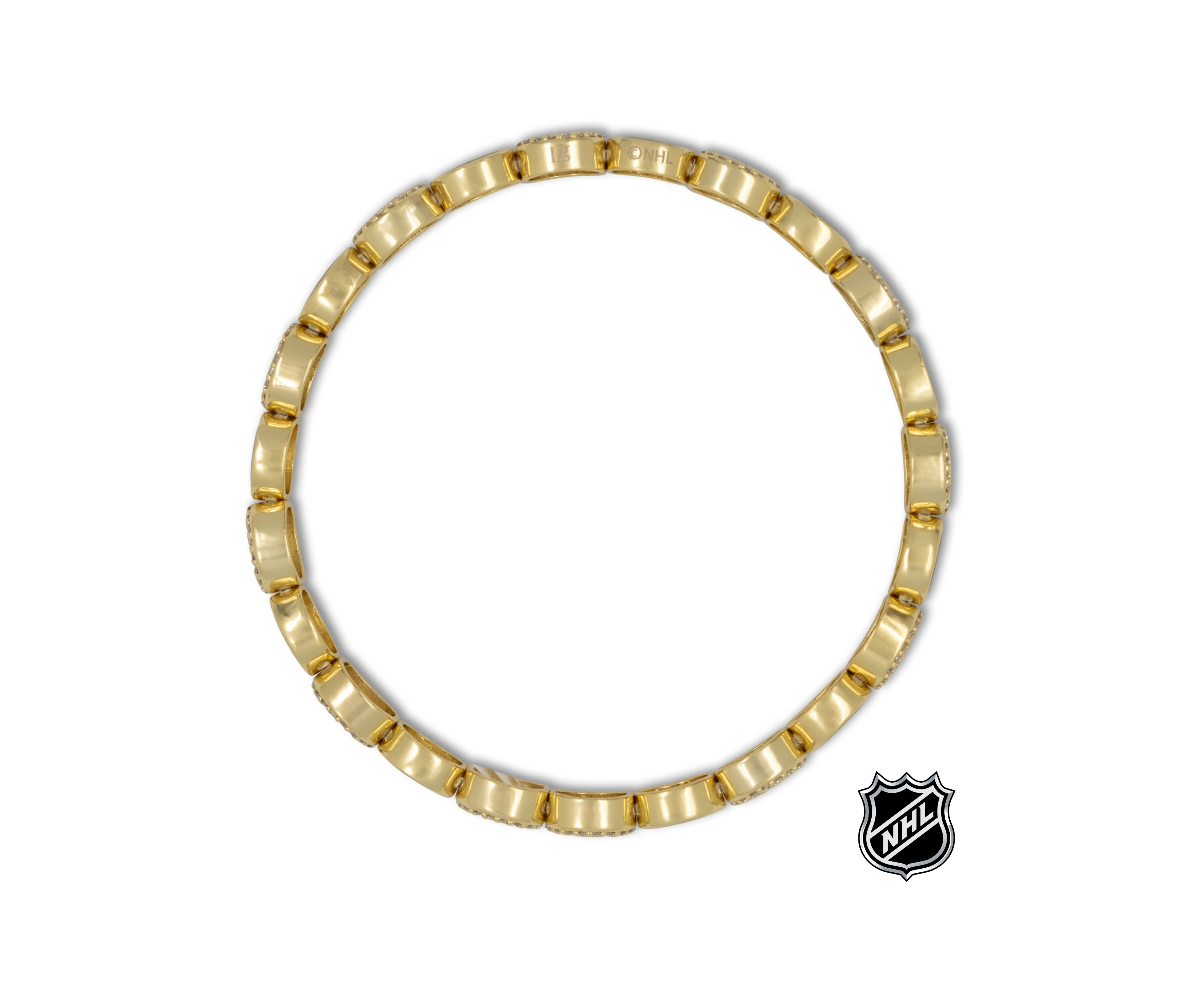 Gold-tone link bracelet with NHL logo charm at the side