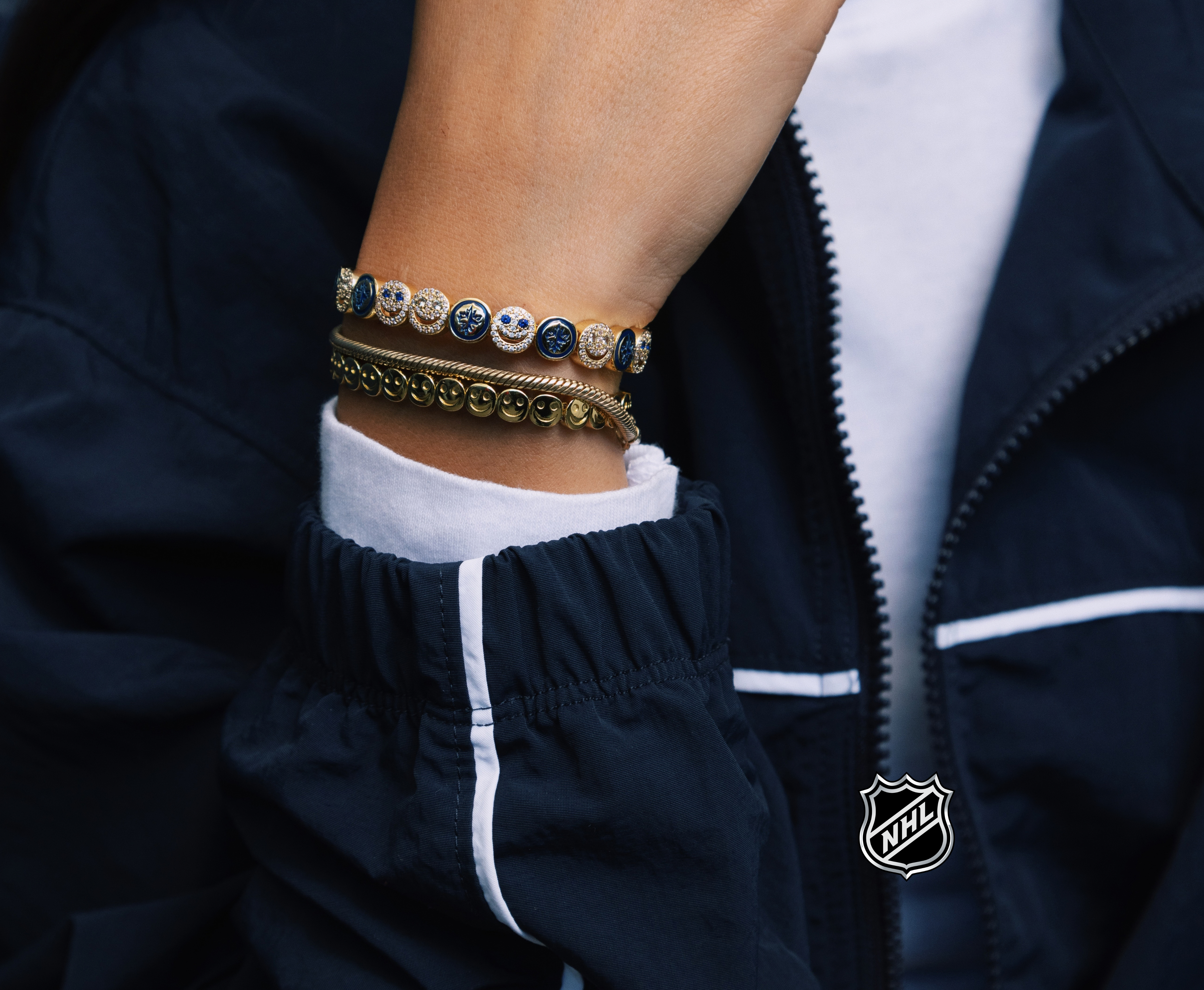 Silver-tone bracelet with circular team logo medallions and beaded chain style