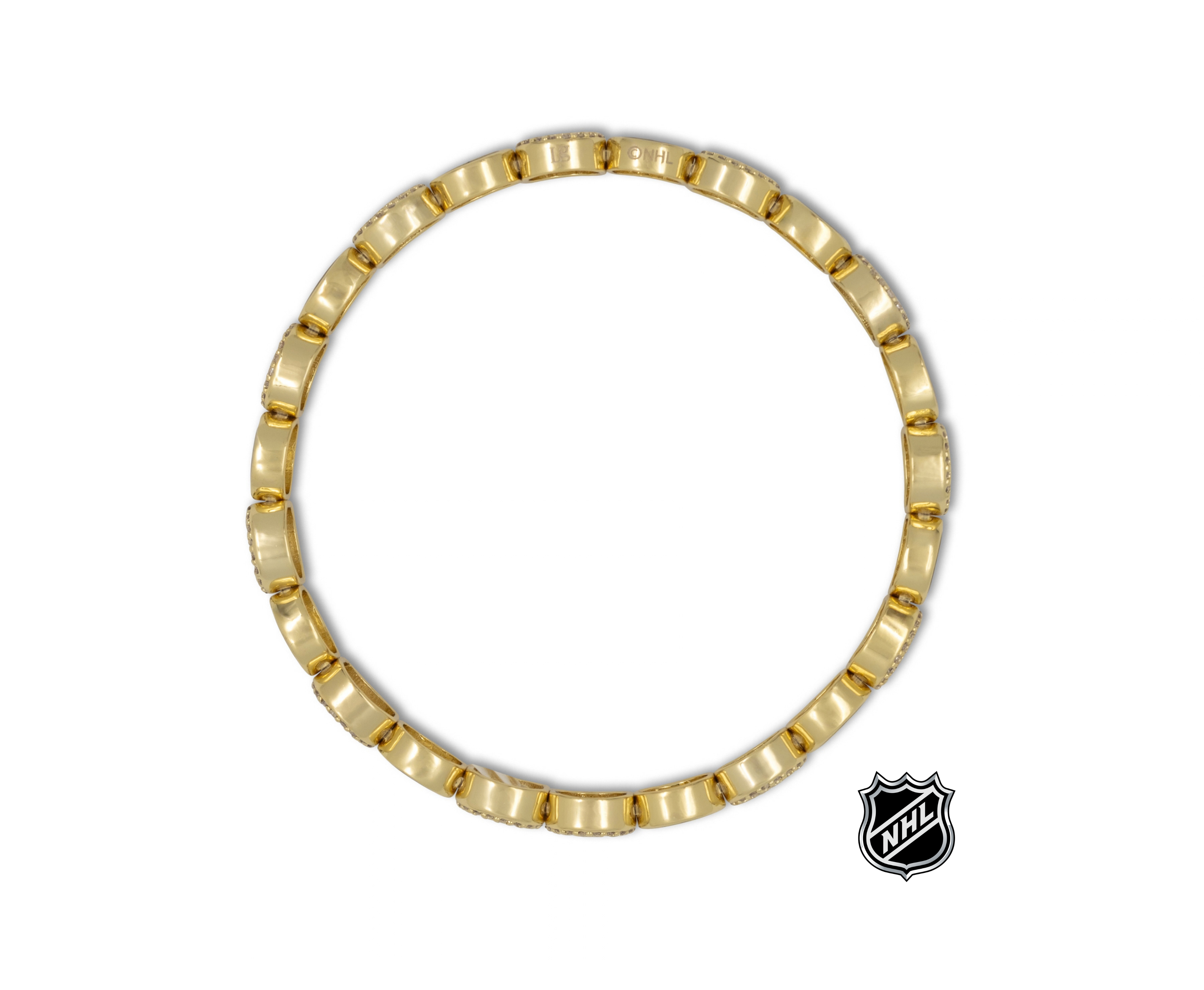 Gold-tone link bracelet with small NHL logo charm at side