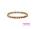 A yellow gold eternity bracelet featuring small heart-shaped purple gemstones set in a row, photographed on a clean white background.