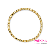 A gold-plated circular ring with a textured, segmented outer edge, shown against a plain white background.