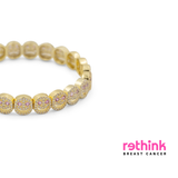 Gold pavé bracelet with round pink stone-set discs