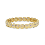 Gold bracelet with small round stones on a white background