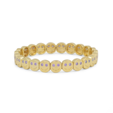 Gold bracelet with small round stones on a white background