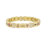 Gold bracelet with various charms on a white background