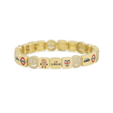 Gold bracelet with various charms on a white background