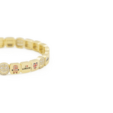 Gold beaded bracelet with various charms on a white background