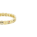 Gold bracelet with various charms on a white background