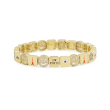 Gold bracelet with various charms on a white background