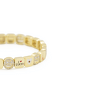 Gold bracelet with various charms on a white background