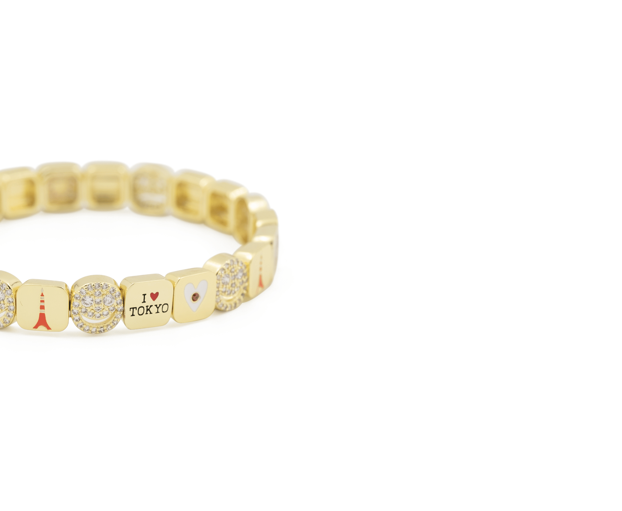 Gold bracelet with various charms on a white background