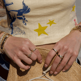 Gold rings and bracelets on a womens wrist