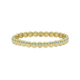 Gold bracelet with blue stones on a white background