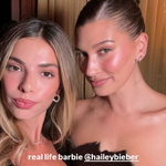 Two women posing together with text overlay 'real life barbie @haileybieber'.